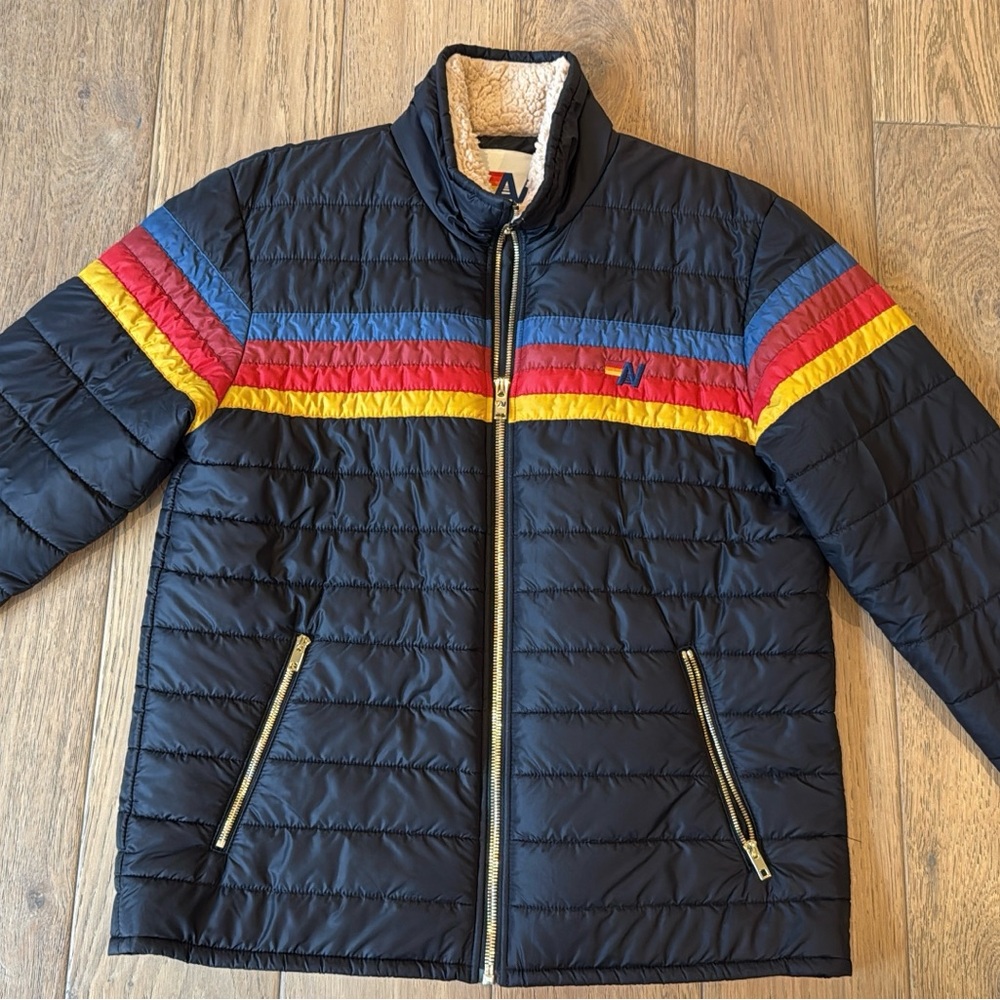 Aviator Nation Black Puffer Jacket with Red, Blue, and Yellow Stripes